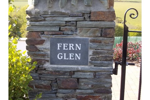 Property name plaque, unpolished black granite, white painted lettering